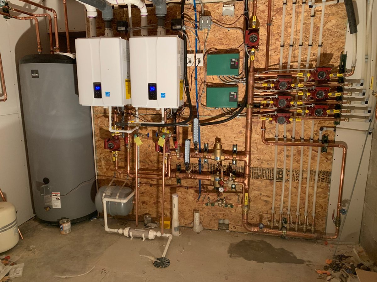 Boiler and circulator piping in a Denver basement mechanical room